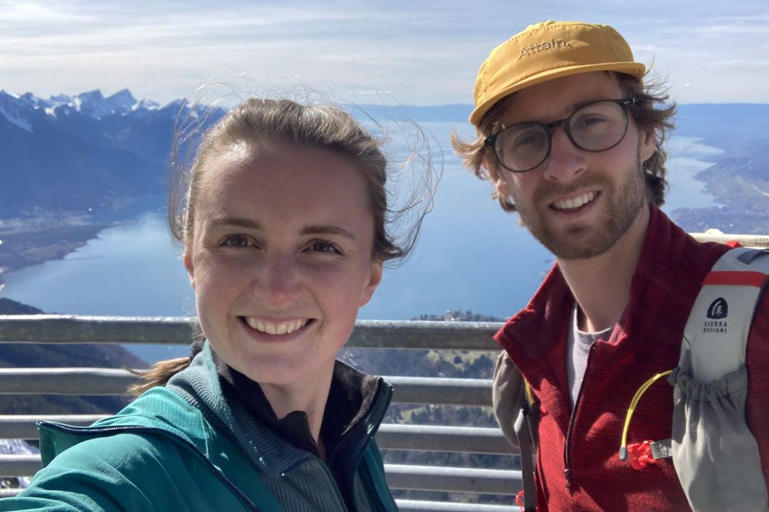 Photo of Paddy and Kani smiling with mountains in the background